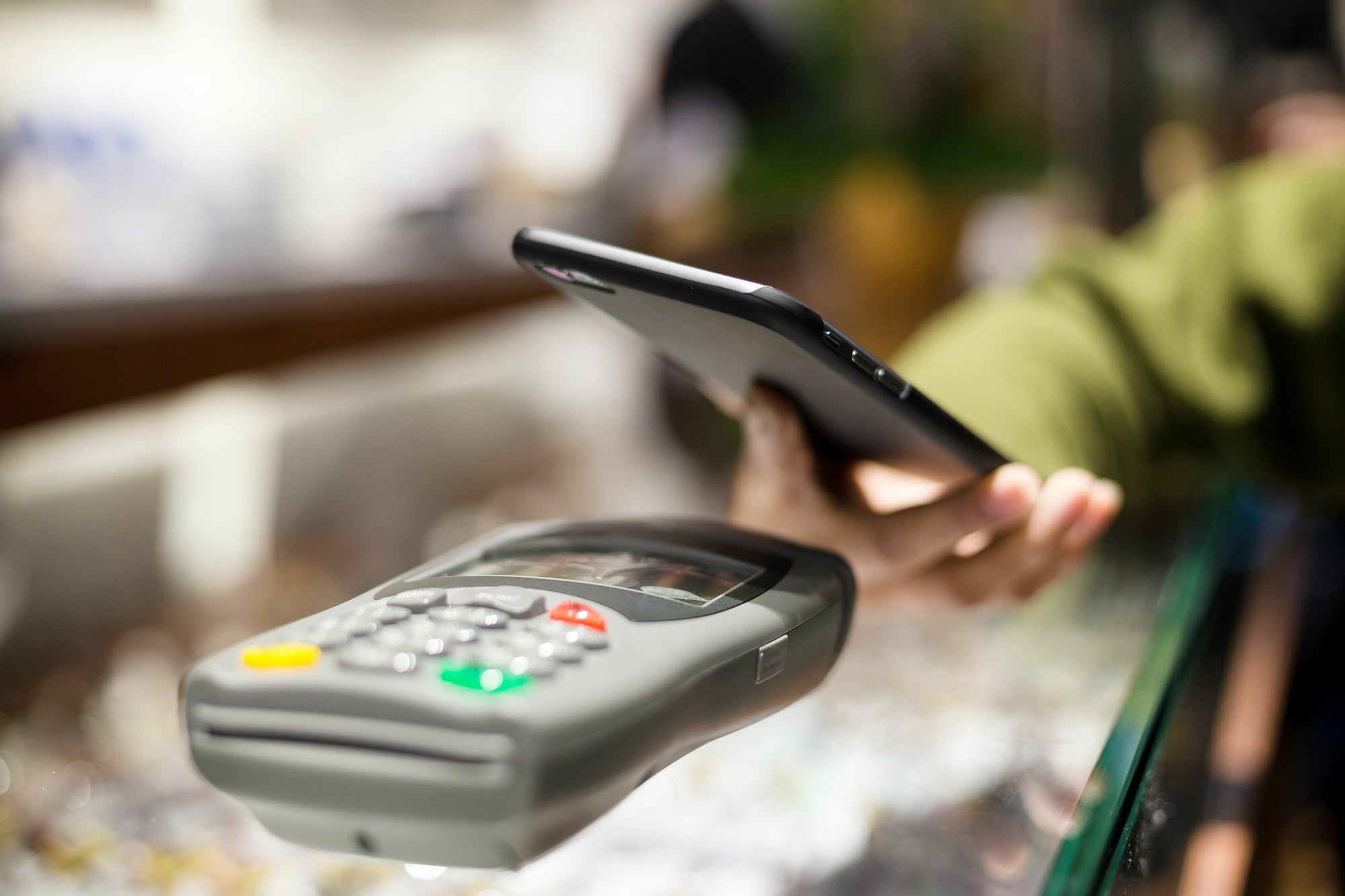 Woman using mobile phone for pay the bill
